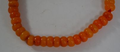 A 20th Century faux amber buddhist prayer bead nec