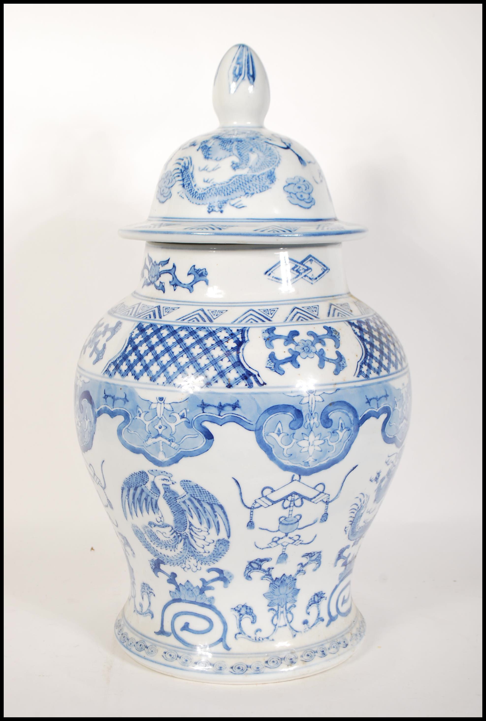 A tall 20th Century Chinese blue and white lidded - Image 2 of 9