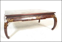 A 20th Century Chinese lacquered burgundy opium ta