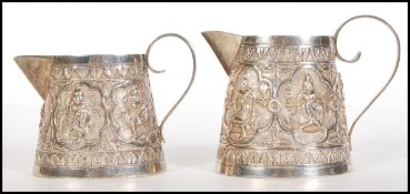 A pair of 20th Century South East Asian silver jug
