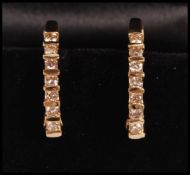 A pair of 14ct gold hoop earrings channel set with