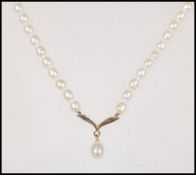 A 9ct gold and cultured pearl necklace and pendant