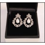 A pair of stamped 925 silver drop earrings set wit