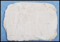 A carved limestone Egyptian wall relief fragment a