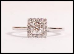 A stamped 18ct white gold ring set with a brillian