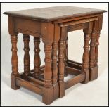 A 20th Century graduating nest of three oak peg jointed side / occasional tables, rectangular flared