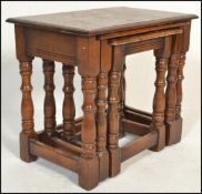 A 20th Century graduating nest of three oak peg jointed side / occasional tables, rectangular flared