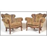 A pair of 20th Century contemporary rococo style  walnut lounge armchairs. Carved pierce show