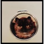 A stamped 925 silver pill box of round form having an enamel panel top depicting a cat. Gross weight