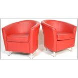 A matching pair of retro 20th Century red leather tub chairs raised on chrome supports. Measures