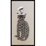 A sterling silver pendant necklace in the form of a cat having a detailed body with pendant hook