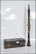 An early 20th Century cased rosewood five piece clarinet, set with nickel buttons and impressed