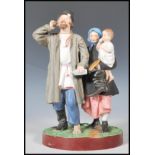 A 19th Century Russian Gardner bisque figurine group depicting a man with one boot and a bottle in