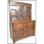 A 20th Century oak dresser sideboard, The upright back with leaded glazed doors with adjustable