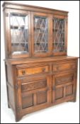 A 20th Century oak dresser sideboard, The upright back with leaded glazed doors with adjustable