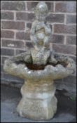 A 20th Century well weather reconstituted garden feature birdbath in the form of a clamshell with