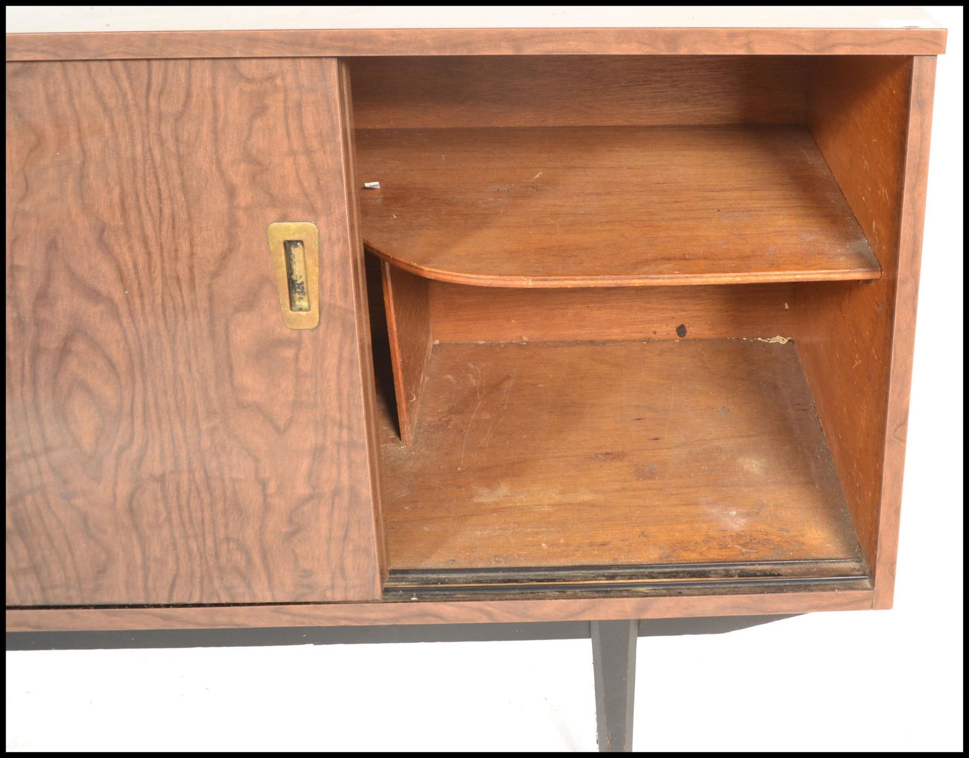 A mid century melamine sideboard credenza being raised on tapering legs with angled wide body - Image 5 of 7