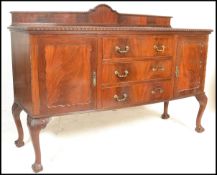 A 1920's mahogany bow front sideboard dresser in the Queen Anne style. Raised on ball and claw