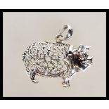 A silver stamped sterling pendant necklace in the form of a pig having a filigree decorated body