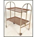 A retro mid century Gerlinol Brenshey Dinett retro chrome folding tea trolley being raised on