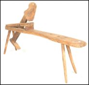 A 19th Century pine wood shaving horse industrial carpenter's workbench having a rounded rectangular