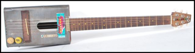 A 20th Century retro Afri-Can electric guitar, the body constructed from a vintage oil can having