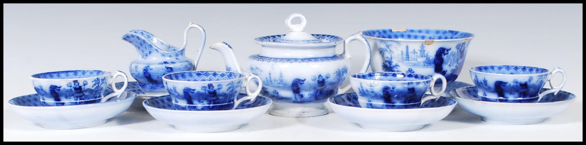 An early 19th Century flow blue / blue and white miniature child's tea service depicting Chinese