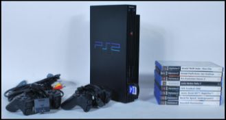 AN ORIGINAL SONY PLAYSTATION 2 AND NINE GAMES