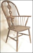 A Victorian 19th century beech and elm wood Windsor chair  / armchair being raised on turned legs