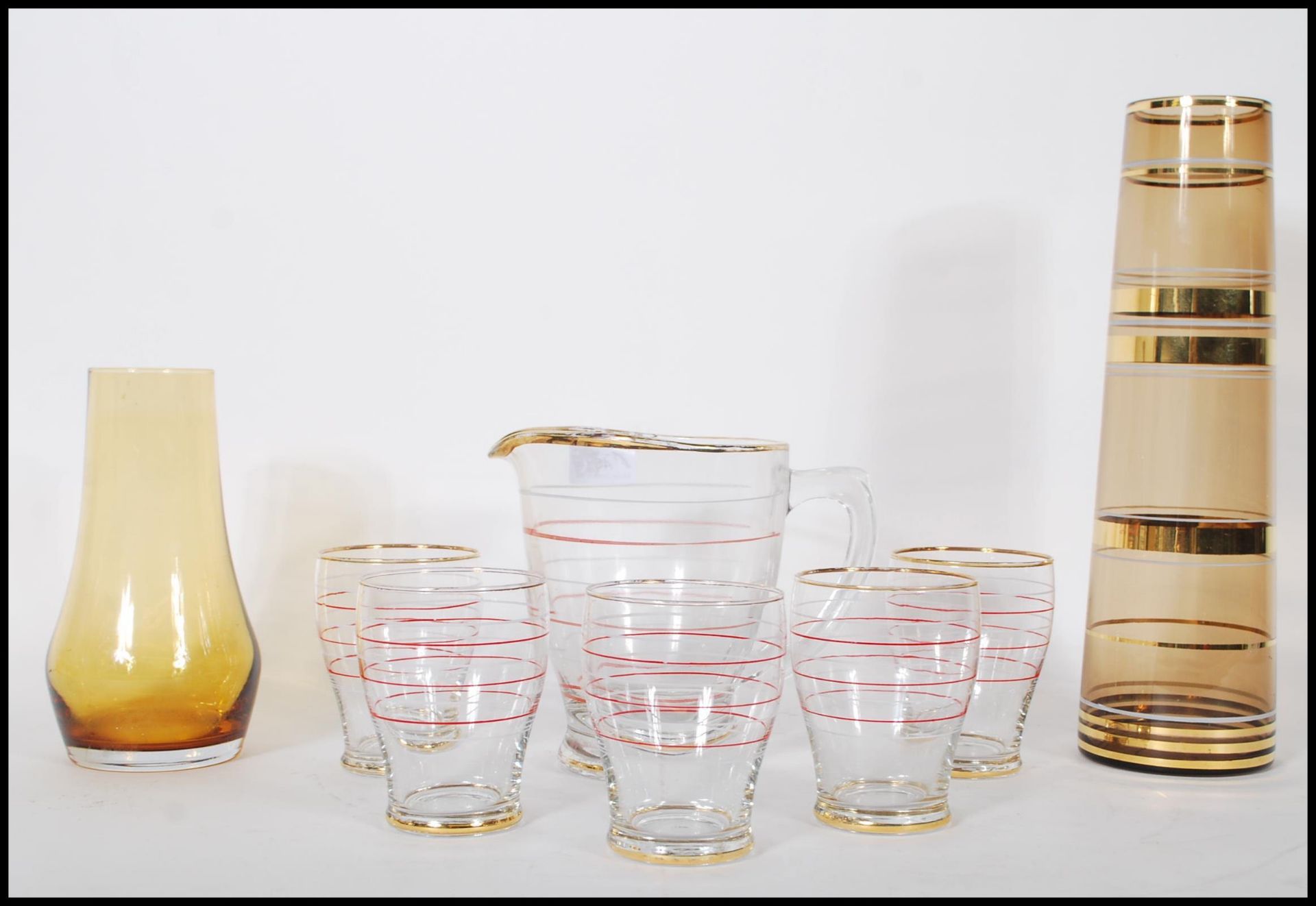 A mid 20th Century lemonade set consisting of a lemonade pitcher together with matching glasses