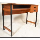 A 20th Century retro teak wood desk, raised on tubular black metal supports, two drawers to the