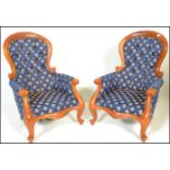A pair of 20th Century contemporary Victorian style walnut spoon back  armchairs being raised on