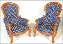 A pair of 20th Century contemporary Victorian style walnut spoon back  armchairs being raised on