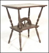 An  early 20th Century oak Arts and Crafts side table having carved floral borders to the top,