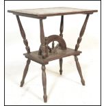 An  early 20th Century oak Arts and Crafts side table having carved floral borders to the top,