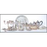 A large collection of silver plate to include salvers, candelabra, teapot, coffee pot. peanut