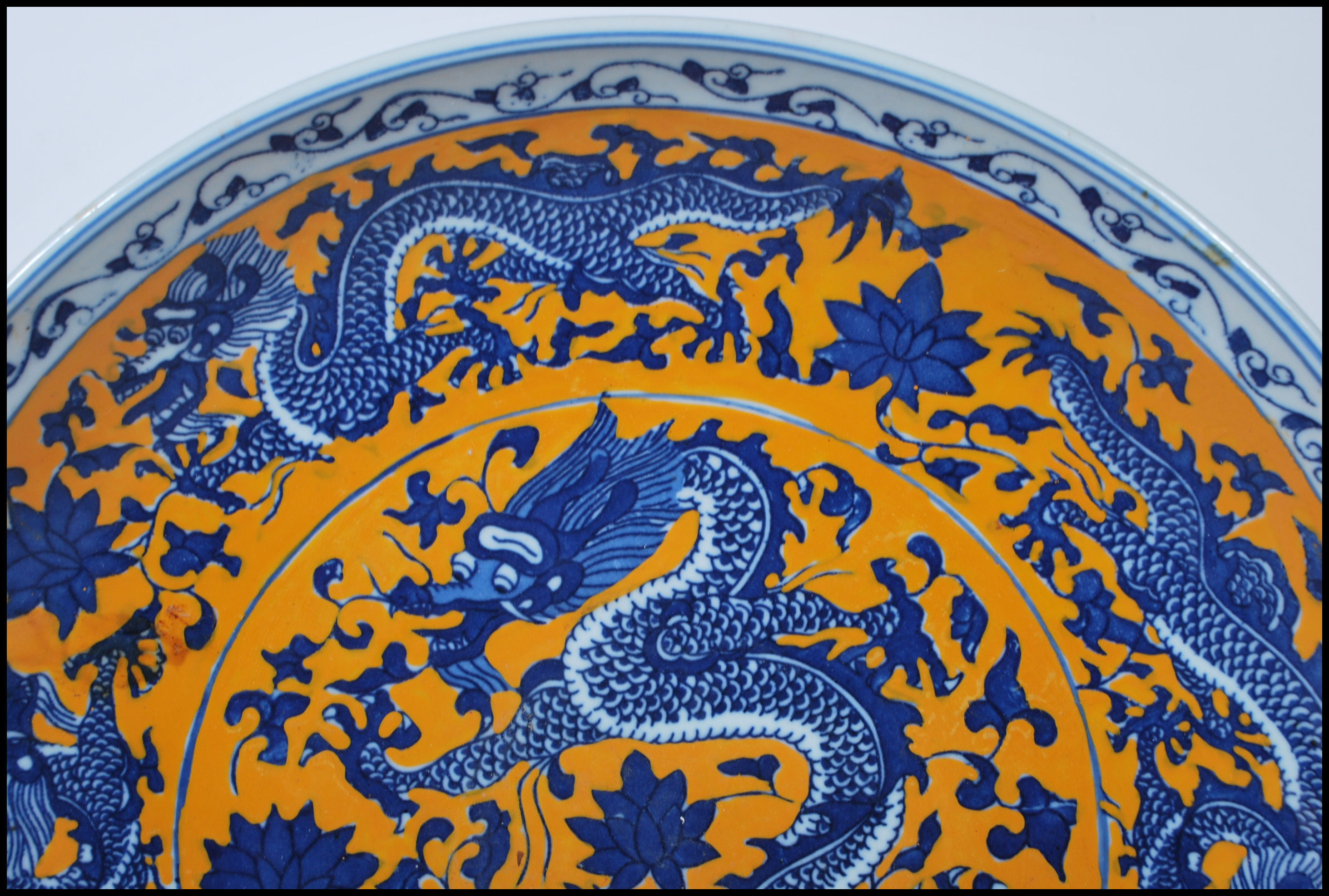 A 20th Century Chinese wall charger having hand painted on a yellow ground with five toed blue and - Image 2 of 6