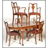 A 20th Century extendable walnut Queen Anne revival dining table of oval form raised on Queen Anne
