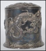 An early 20th Century Chinese silver plated tobacco / cigar box of cylindrical form embossed with