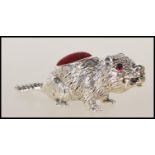A stamped 925 silver pincushion in the from of a beaver having a red velvet pincushion to the back