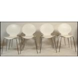 A set of Galvano Tecnica Italian white plastic formed shell dining stacking chairs having a shell