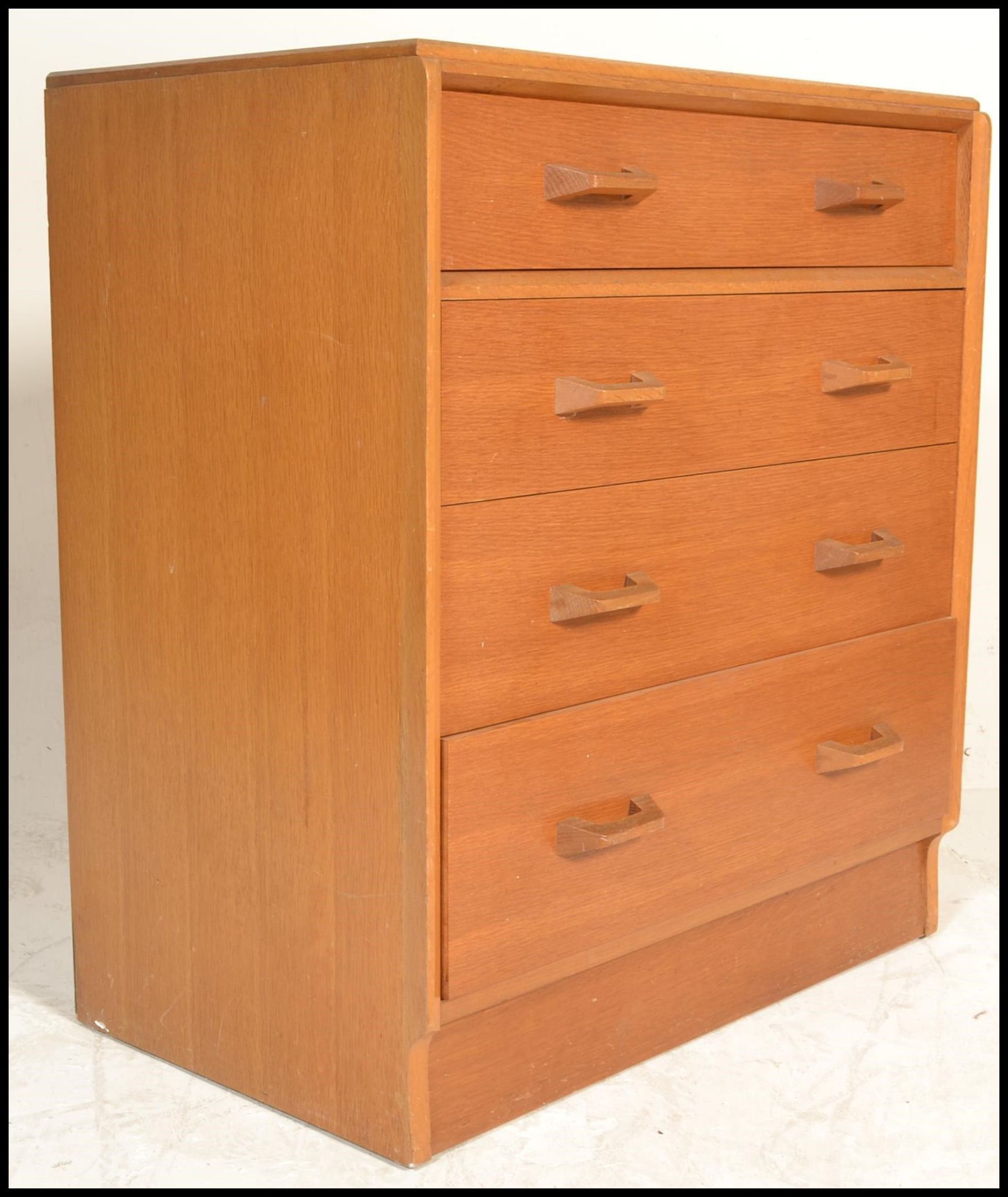 E. Gomme- G Plan- Brandon Range- A  20th Century light oak chest of drawers. The chest consisting of