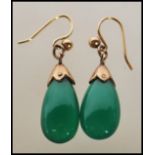 A pair of 20th century vintage ladies drop earrings set with polished teardrop green jade style