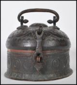A 19th Century Indian beaten metal Paan Daan Betel / spice nut caddy box of round form having a