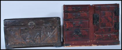 A late 19th Century Chinese carved wooden table top box decorated with carved panels depicting