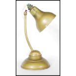 A mid 20th Century 1940's vintage metal industrial ball joint desk table lamp raised on a round