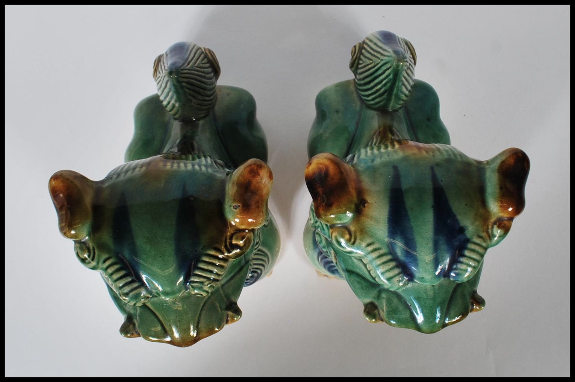 A pair of mid 20th Century Chinese porcelain temple lions / dogs of  Fu. Both modeled with a jade - Image 5 of 6