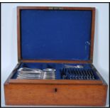 A Victorian 19th century oak cased canteen of cutlery having campaign style handles. The contents