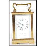 A 20th Century brass carriage clock by Mappin and Webb having a white enamelled face with roman