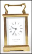 A 20th Century brass carriage clock by Mappin and Webb having a white enamelled face with roman